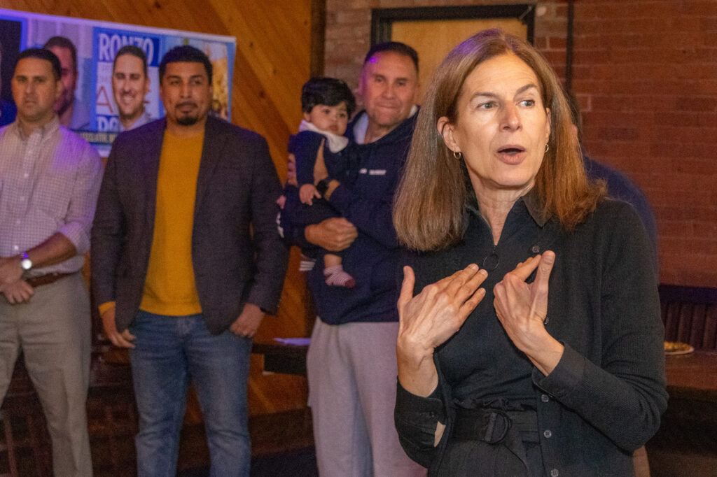 Dr Frank Gerratana photo. Lt Gov Susan Bysiewicz (D) speaks, while state representative candidate David DeFronzo, Rep Manny Sanchez (D-24) and Rep Bobby Sanchez (D-25) listen.